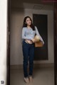 A woman standing in an elevator holding a basket.