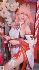 A woman with pink hair is posing for a picture.