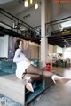 A woman sitting on top of a couch in a living room.