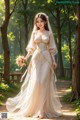 A woman in a wedding dress walking down a path in the woods.