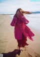 A woman taking a picture of herself on the beach.